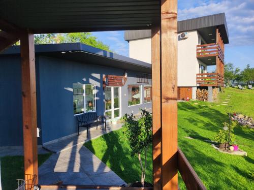 a house with a view of a yard at ZEN Apartments in Măgura