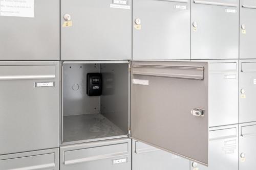 a row of lockers with a phone in the middle at Core Luxembourg -Studio Parking -50 Cents in Luxembourg