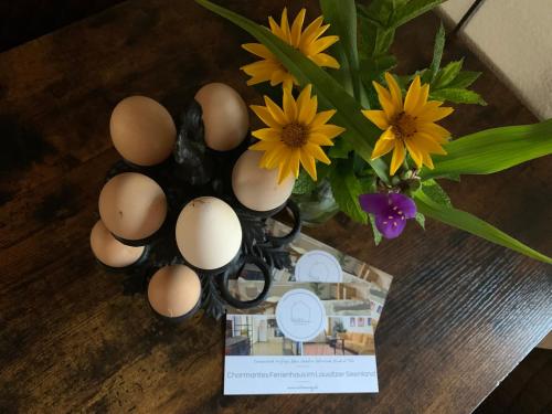 a vase filled with eggs and flowers on a table at Willma Ferienhaus in Altdöbern