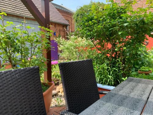 two chairs and a table on a patio at Willma Ferienhaus in Altdöbern