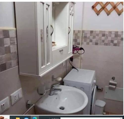 a bathroom with a sink and a medicine cabinet at La Casa di Anna in Lampedusa