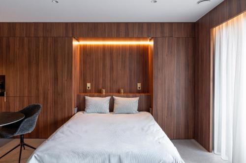 a bedroom with a large bed with wooden walls at Core Luxembourg -Studio Parking -50 Cents in Luxembourg