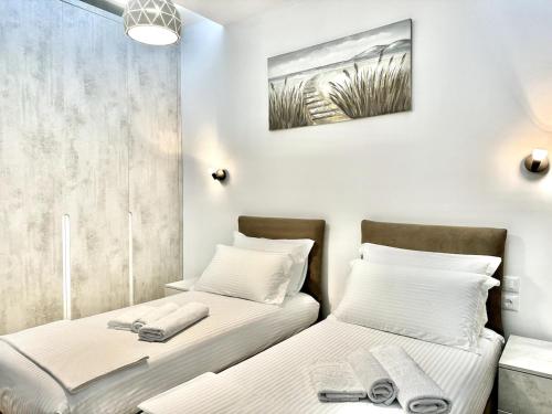 two beds sitting next to each other in a room at Olive Garden Villa in Himare