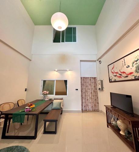 a living room with a table and a dining room at 財家 Chai House NEAR Lee Garden,Private parking in Hat Yai