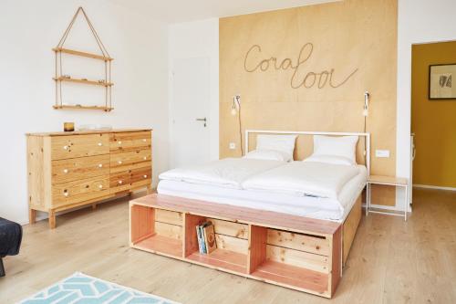 a bed in a room with a sign on the wall at Vlnka Apartments in Piešťany