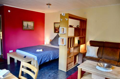 a room with a bed and a couch and a table at Ferienwohnung an der Örtze in Müden
