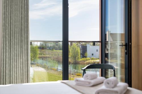 a bathroom with a view of a window with towels at The Lark Ascending BR11 Silverlake Dorset in Warmwell