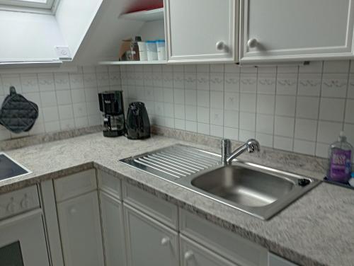 a kitchen counter with a stainless steel sink at FeWo Christine in Bad Buchau