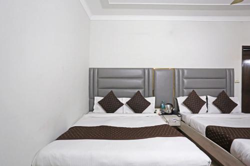 two beds sitting next to each other in a room at Hotel Ratandeep at Paharganj in New Delhi