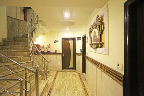 a hallway with a staircase in a house at Hotel Ratandeep at Paharganj in New Delhi