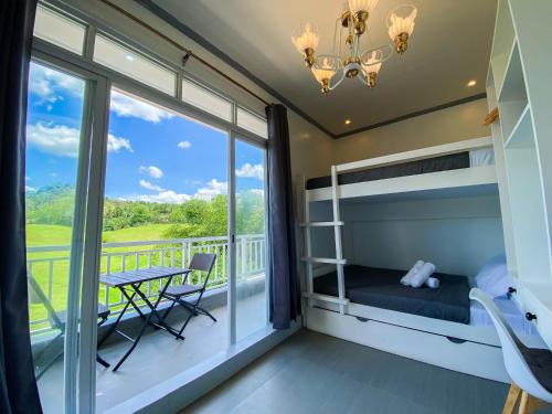 a bedroom with a bunk bed and a balcony at Ronina's Sipocot Hotel in Sipocot