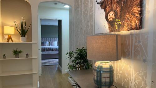 a lamp sitting on a table in a living room at Loch Ness Cottages in Brackla
