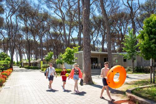 a group of people walking in front of a house at Fabulous village in Casal Palocco