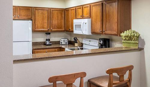 a kitchen with wooden cabinets and a white refrigerator at Wyndham South Shore 1BR Apartment with Resort Access in Zephyr Cove