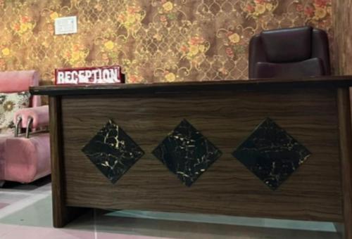a reception desk with a chair in a room at Hotel yash raj Palace Raibarelly in Rāe Bareli