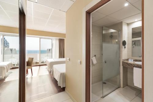 a hotel room with two beds and a bathroom at Hotel Best Indalo in Mojácar