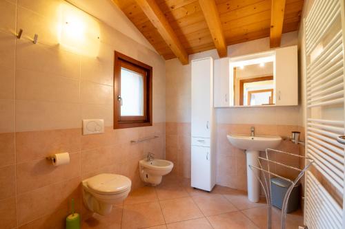 a bathroom with a toilet and a sink at Albergo Diffuso Balcone sul Friuli in Clauzetto