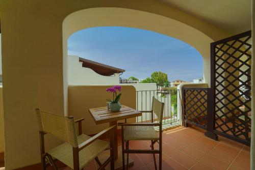 a balcony with a table and chairs on a balcony at Hotel La Caletta Village in La Caletta