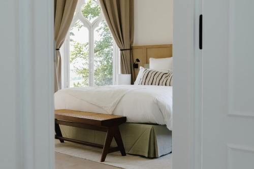 a bedroom with a large bed and a window at Les Hauts de Sancerre in Sancerre