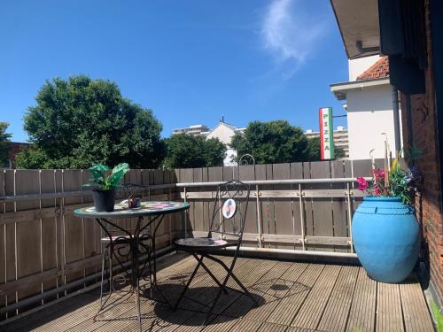 a patio with a table and two chairs on a deck at The Rock in Zandvoort