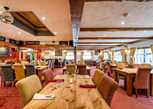 a dining room with wooden tables and chairs at Tocketts Mill Country Park in Upleatham