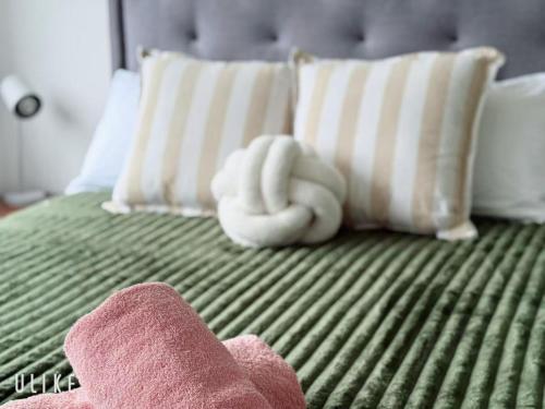 a stuffed animal is laying on a bed at Cozy Stay 4BR Townhouse in Pimpama