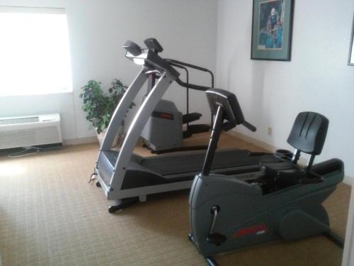 a gym with a treadmill and a chair in a room at Motel 6-Maryland Heights, MO in Maryland Heights