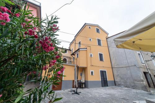 a building with pink flowers in front of it at B&B Magliuolo in San Giovanni a Piro