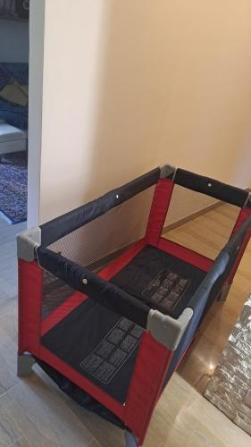 a small bed with a red and black frame at TataBlu residenza con parcheggio in Florence