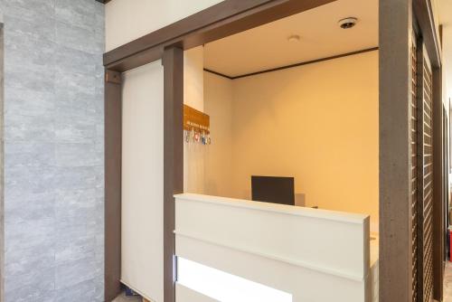 an office with a sliding glass door with a desk at Villa FUN Kawana in Ito