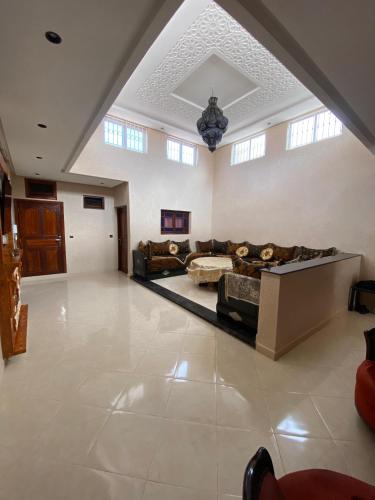 a large living room with couches and a ceiling at villa cherif in Azib Oulad Lâdem