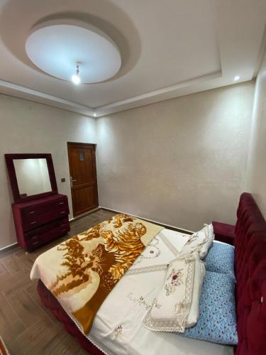 a bedroom with a bed and a couch in a room at villa cherif in Azib Oulad Lâdem