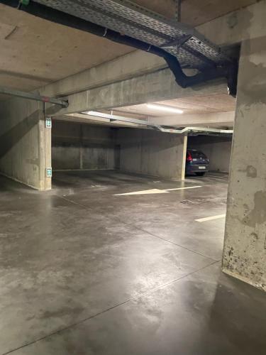 an empty parking garage with a car parked in it at Ch'ti Lillois - Appartement 3 personnes Lille in Lille
