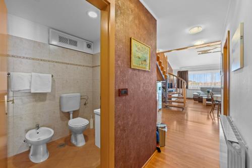 a bathroom with a toilet and a sink at Olea Magica Apartments in Rovinj