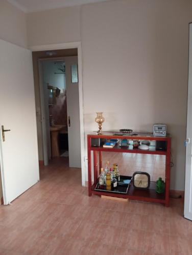 a room with a table with a stove in it at Alexishome in Oropós