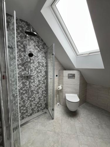 a bathroom with a shower and a toilet at Przystanek Zator in Zator