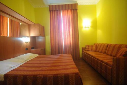 a hotel room with a bed and a couch at Friendship Palace in Rome