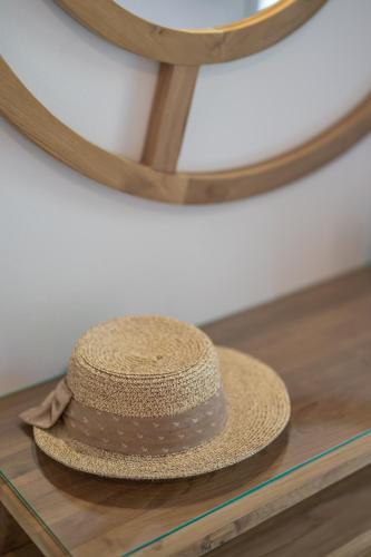 a straw hat sitting on a table in front of a mirror at SKYROS AVRA Residences in Skiros