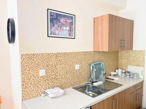 a kitchen counter with a sink and a sink at Linda House Corfu in Gastouri