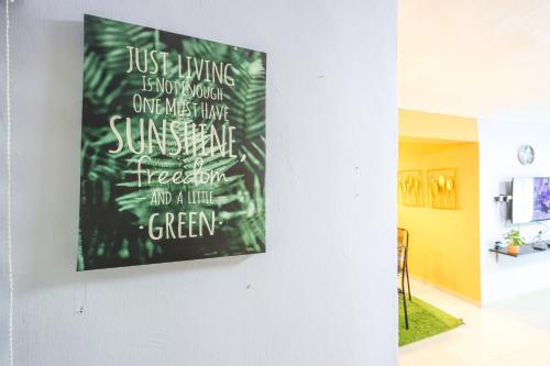 a painting hanging on a wall in a living room at Modern Family Suite in Cameron Highlands Clover Home K2 in Cameron Highlands