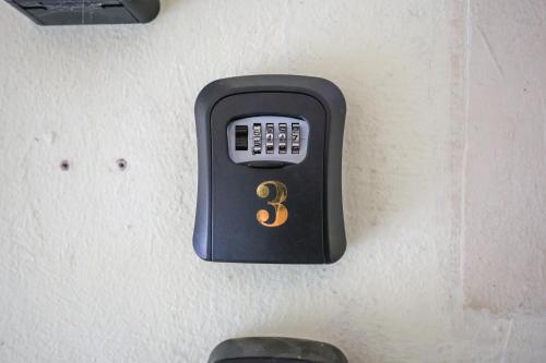 a soap dispenser on a wall with a number three at Modern Family Suite in Cameron Highlands Clover Home K2 in Cameron Highlands
