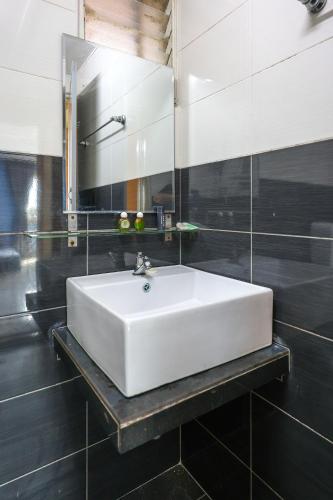 a bathroom with a white sink and a mirror at Modern Family Suite in Cameron Highlands Clover Home K2 in Cameron Highlands