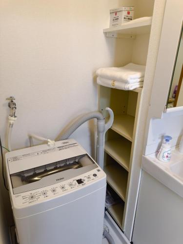 a laundry room with a washer and dryer at The Prime Minato 3 Beds Suite Near Tokyo Tower, 2 Mins Walk to Asakusa Line, Direct Access From HND, NRT Airport in Tokyo
