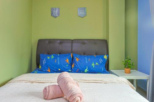 a bed with a stuffed animal laying on it at Modern Family Suite in Cameron Highlands Clover Home K2 in Cameron Highlands