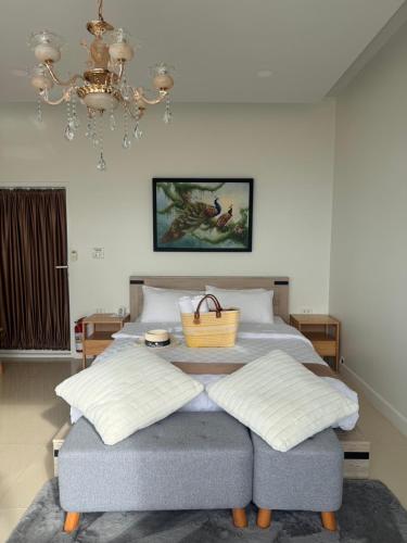a bedroom with a bed with a basket on it at Cheevavavee Doichang Chiangrai in Ban San Pu Loei