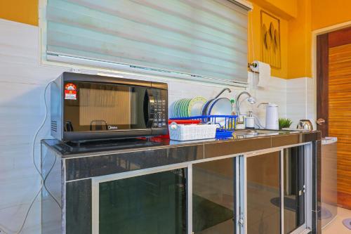 a kitchen counter with a microwave on top of it at Modern Family Suite in Cameron Highlands Clover Home K2 in Cameron Highlands