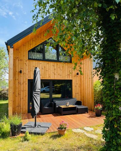 a house with a couch and an umbrella on a patio at Forest Mood in Wieck