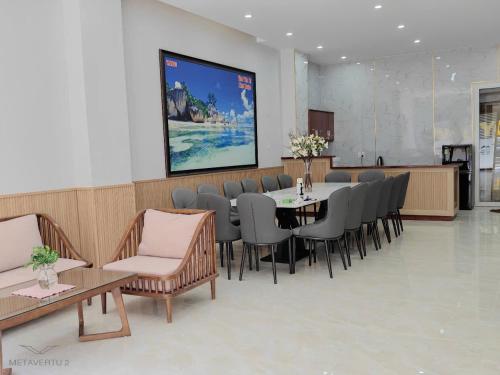 a waiting room with a table and chairs at Thatico Homestay in Kinh Dinh