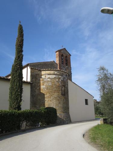 an old stone building with a tower on a road at CasaLeTolfe Residence in Siena