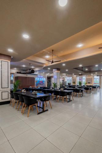 a dining room with tables and chairs in a building at Hotel Highway King Neemrana in Neemrana